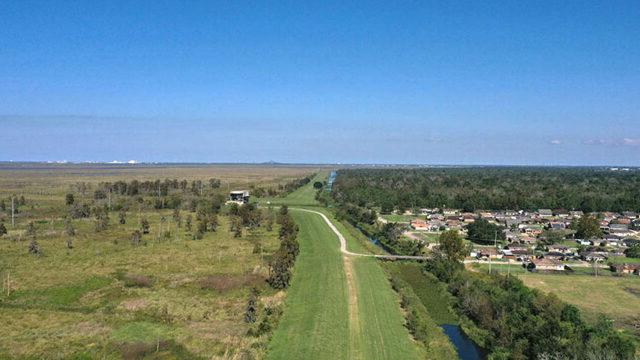 View along the earthen levee—Central Wetlands is the flooding source (right) and protection is provided to adjacent residents